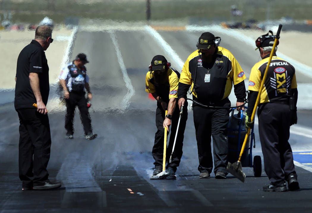 A track crew ensures it's ready for the next round during the NHRA Mello Yellow Drag Racing Ser ...