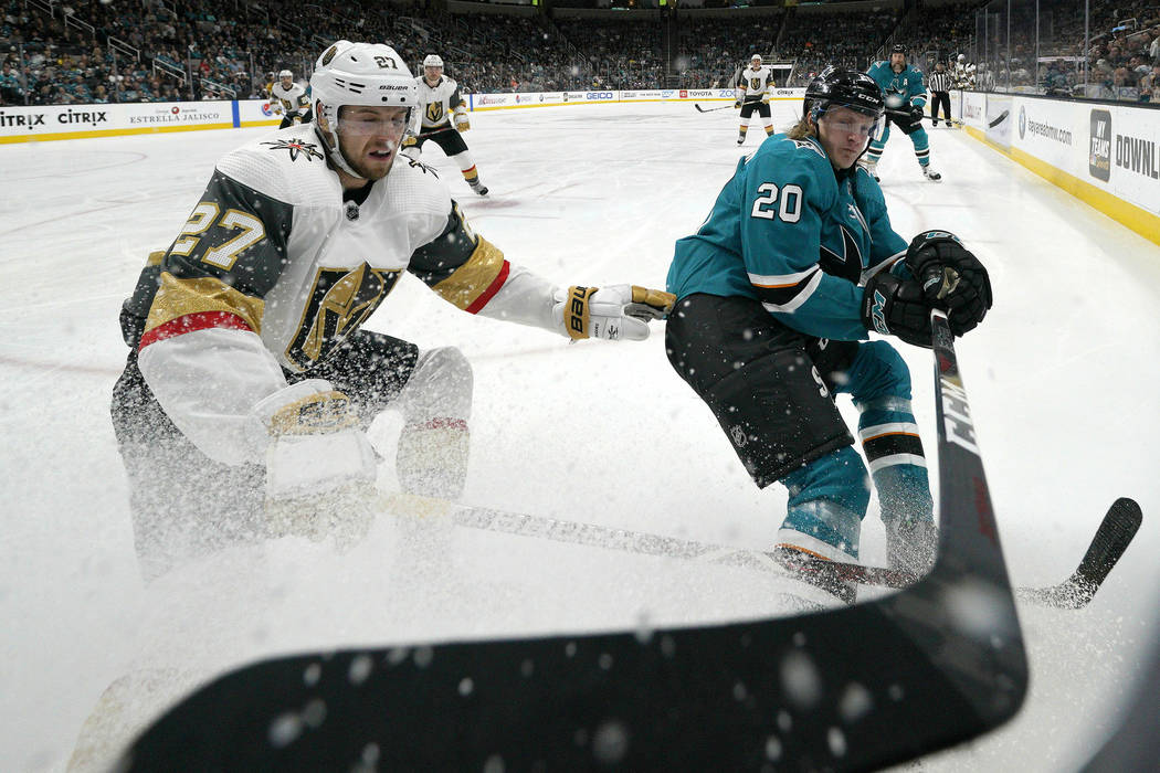 Vegas Golden Knights defenseman Shea Theodore (27) battles for the puck against San Jose Sharks ...