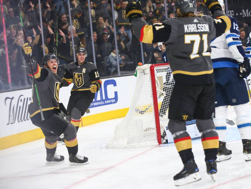 Golden Knights center Jonathan Marchessault, left, celebrates a goal by Golden Knights center W ...