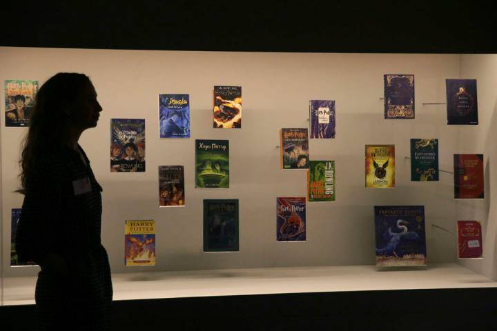 A member of British Library staff poses Oct. 18, 2017, for a picture with Harry Potter books pu ...