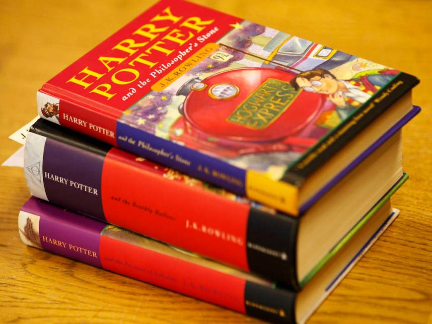 A first edition of 'Harry Potter and the Philosopher's Stone' by J K Rowling, top, a first edit ...