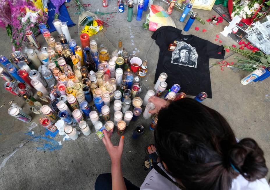 Fans of rapper Nipsey Hussle appear at a makeshift memorial in the parking lot of Hussle's Mara ...