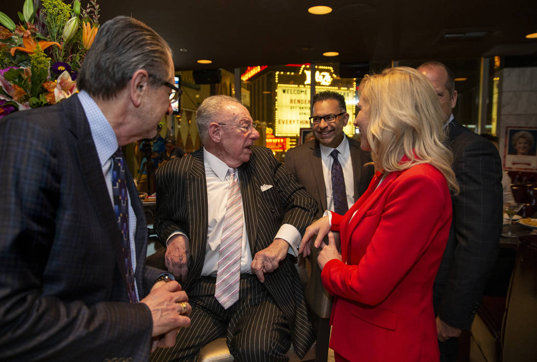 Former Las Vegas Mayor Oscar Goodman chats with his daughter Cara and other while standing in f ...