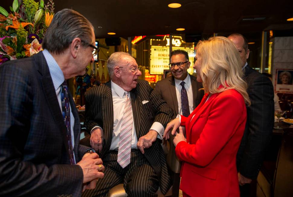 Former Las Vegas Mayor Oscar Goodman chats with his daughter Cara and other while standing in f ...