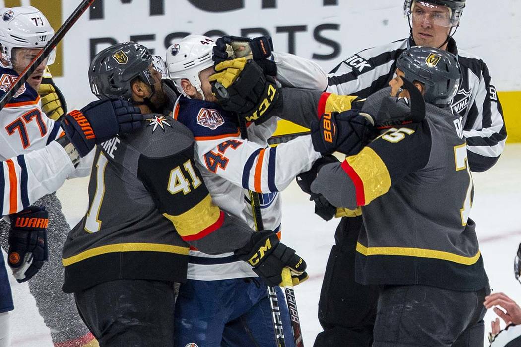 Golden Knights right wing Ryan Reaves (right) connects with a glove to the face of Edmonton Oil ...