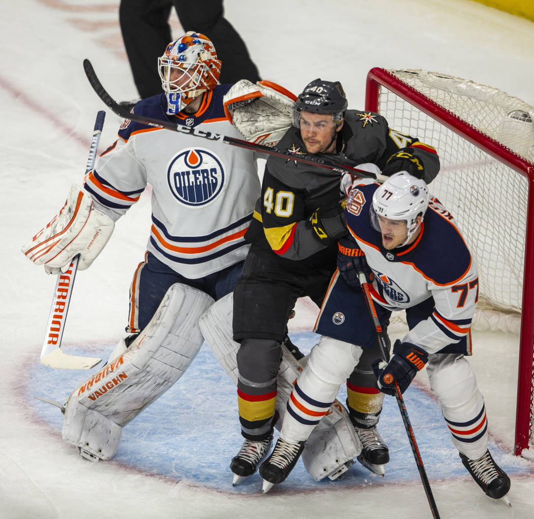 Edmonton Oilers goaltender Mikko Koskinen (19) battles Vegas Golden Knights center Ryan Carpent ...