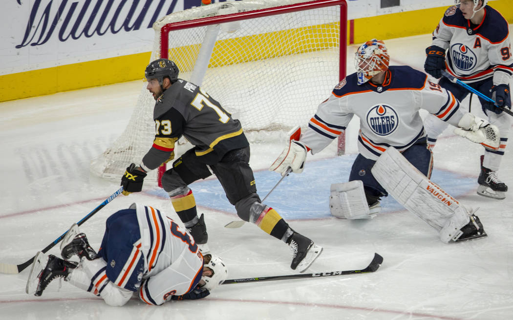 Edmonton Oilers defenseman Matt Benning (83) is down injured as Vegas Golden Knights center Bra ...