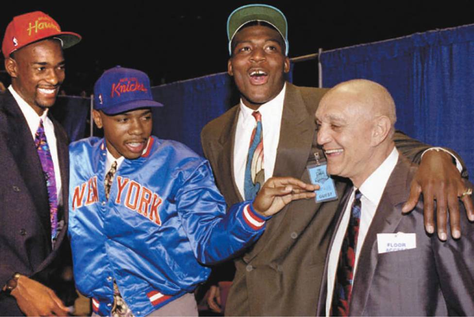 University of Nevada-Las Vegas coach Jerry Tarkanian celebrates with three of his Runnin' Rebel ...