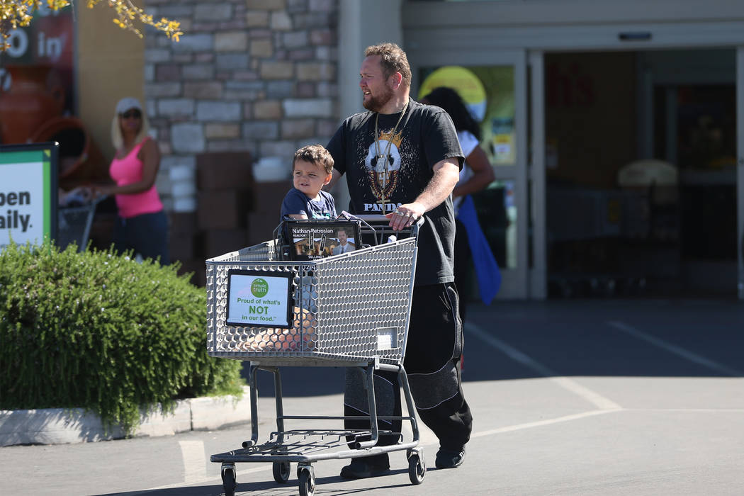 Tom Brown with his nephew Timmy Brown walk to their car after shopping at Smith's, 10600 Southe ...