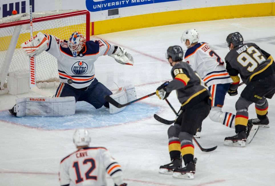 Edmonton Oilers goaltender Mikko Koskinen (19) takes a puck to the chest as Vegas Golden Knight ...