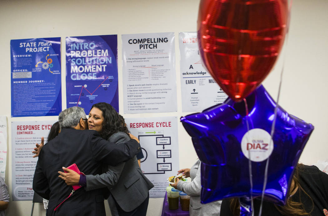 Fernando Romero, president of Hispanics in Politics, left, hugs former assemblywoman Olivia Dia ...