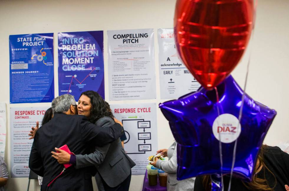 Fernando Romero, president of Hispanics in Politics, left, hugs former assemblywoman Olivia Dia ...