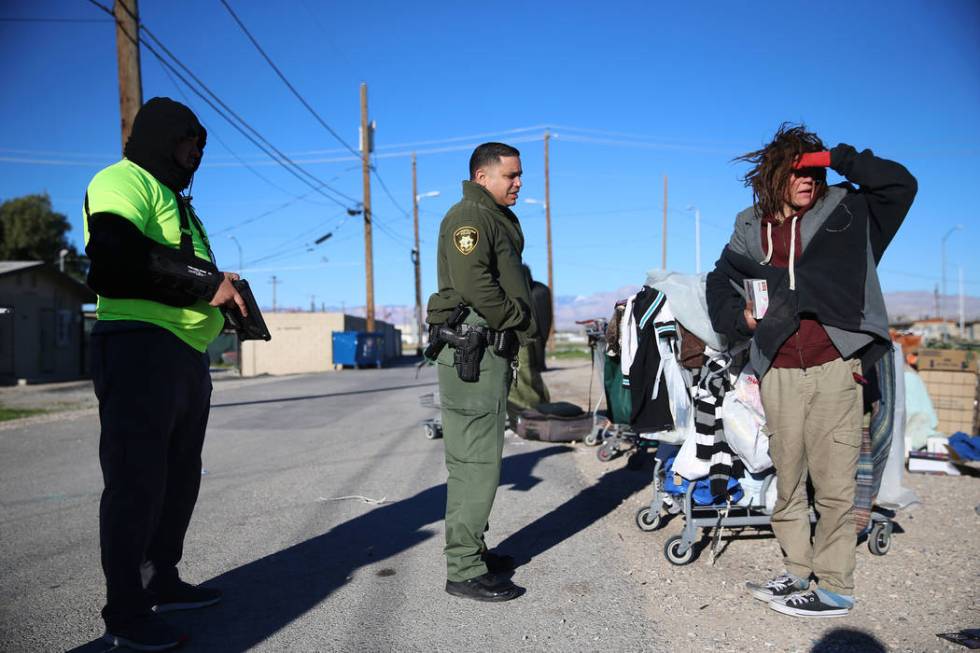 David Lopez, from left, outreach specialist for U.S. Vets, with Las Vegas police officer Angel ...