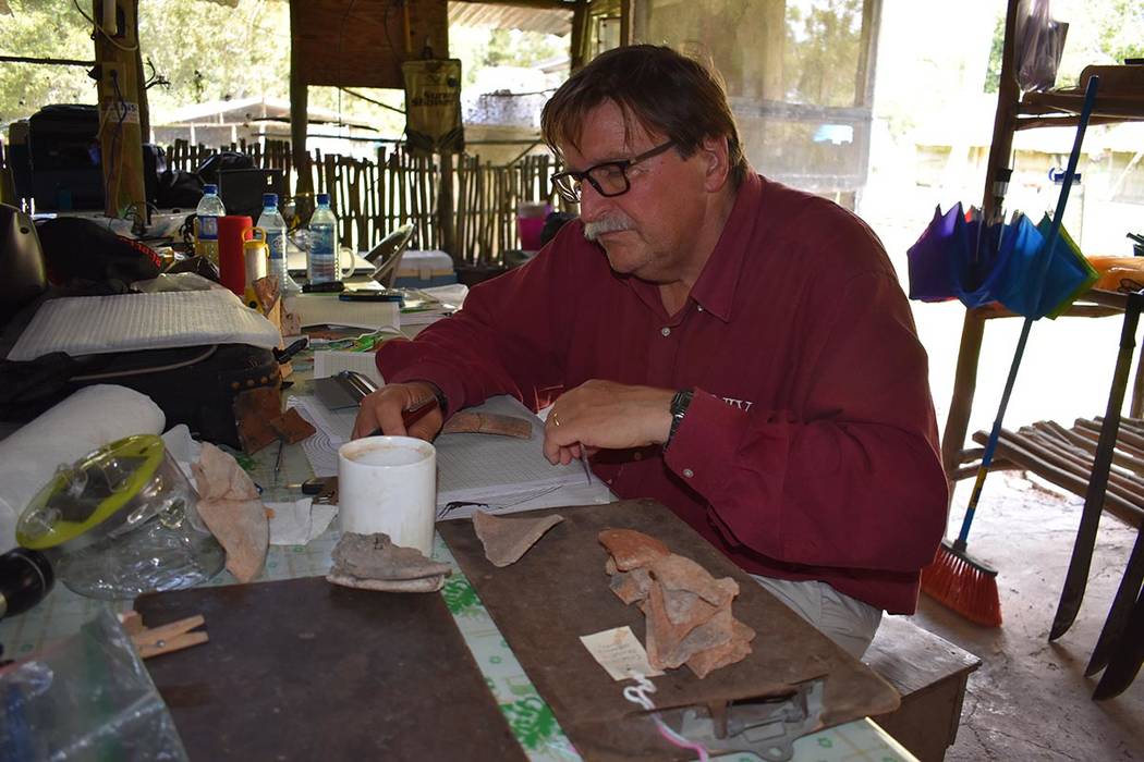 UNLV anthropologist Arlen Chase examines pieces of pottery at the Maya ruin site of Caracol in ...