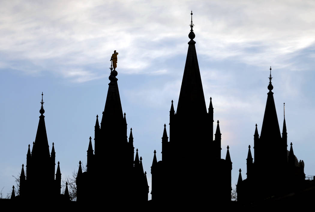 In this Jan. 3, 2018, file photo, the angel Moroni statue, silhouetted against the sky, sits at ...