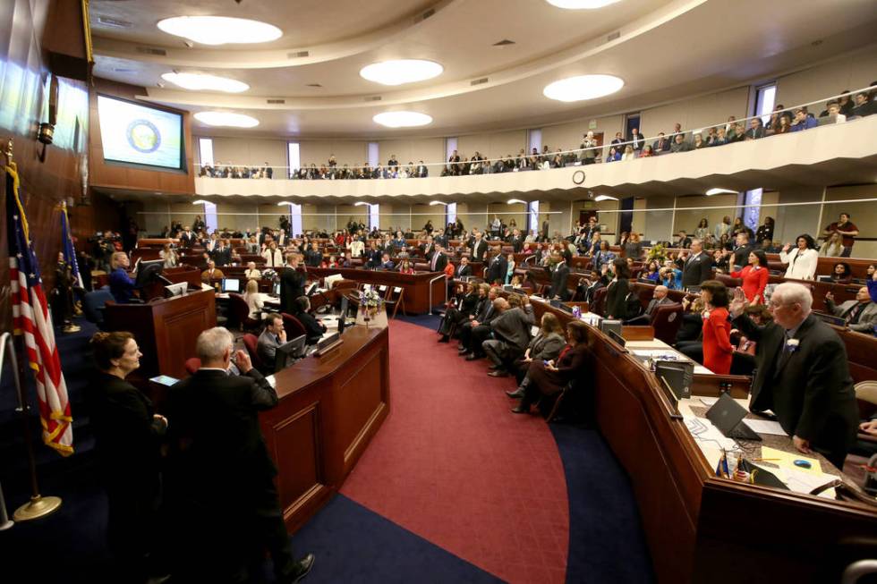 Assembly members take the oath of office in the Legislative Building in Carson City on the firs ...