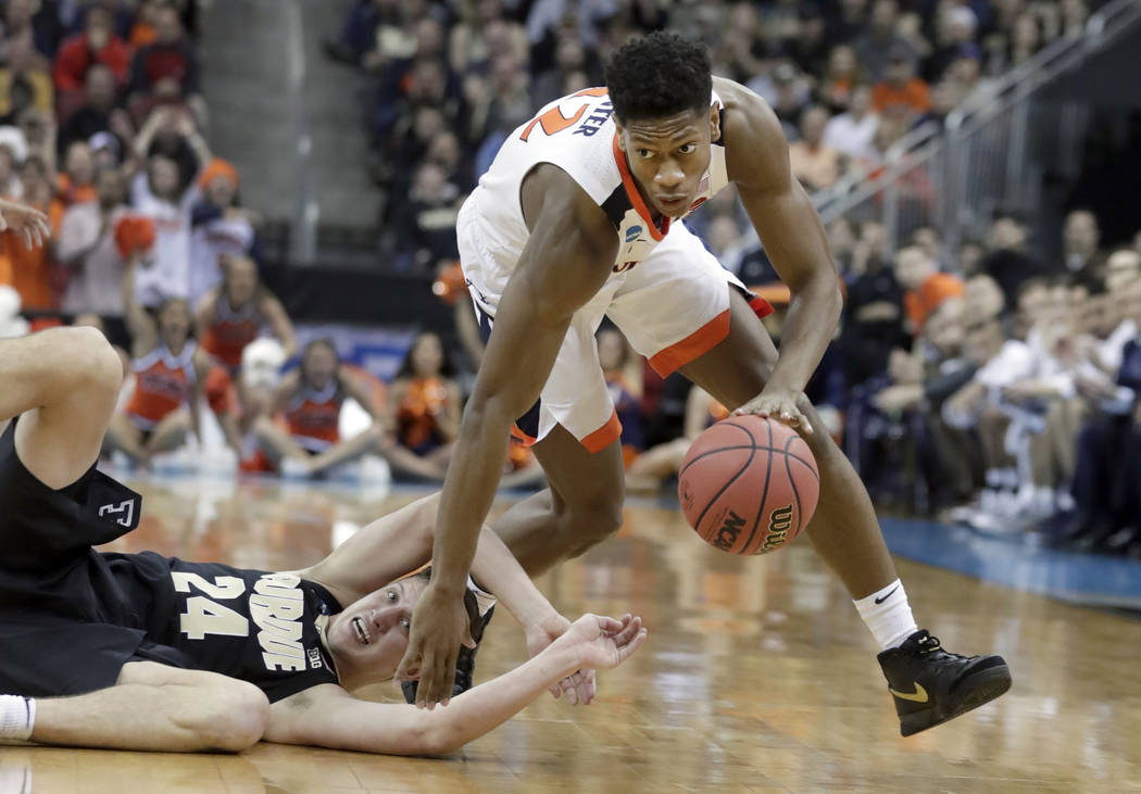 FILE - In this March 30, 2019, file photo, Virginia's De'Andre Hunter dribbles past Purdue's Gr ...