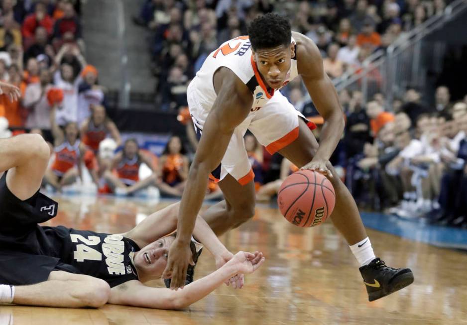 FILE - In this March 30, 2019, file photo, Virginia's De'Andre Hunter dribbles past Purdue's Gr ...