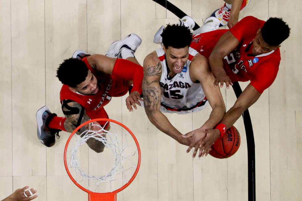 Texas Tech guard Jarrett Culver, right, fouls Gonzaga forward Brandon Clarke, middle, as guard ...