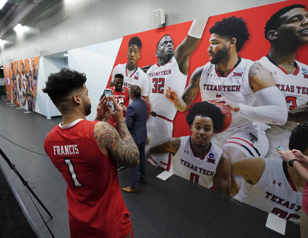 Texas Tech's Brandone Francis takes a picture of his picture after a practice session for the s ...