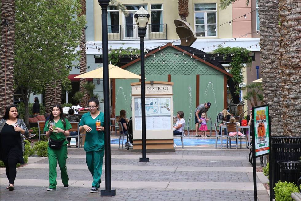 People walk at The District in Henderson, Thursday, April 4, 2019. Erik Verduzco Las Vegas Revi ...