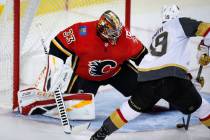Vegas Golden Knights' Reilly Smith, right, scores on Calgary Flames goalie David Rittich, of th ...