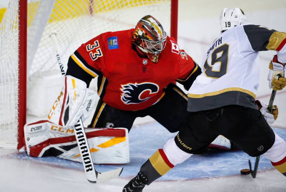 Vegas Golden Knights' Reilly Smith, right, scores on Calgary Flames goalie David Rittich, of th ...