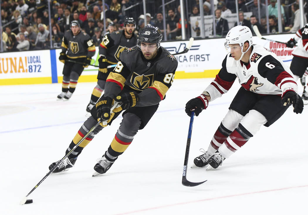 Golden Knights right wing Alex Tuch (89) moves the puck against Arizona Coyotes defenseman Jako ...