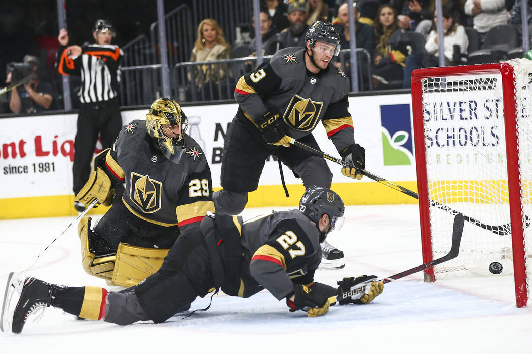 Golden Knights goaltender Marc-Andre Fleury (29), alongside defensemen Shea Theodore (27) and B ...