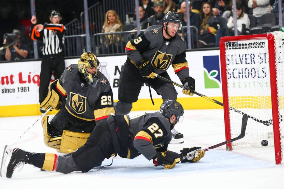 Golden Knights goaltender Marc-Andre Fleury (29), alongside defensemen Shea Theodore (27) and B ...