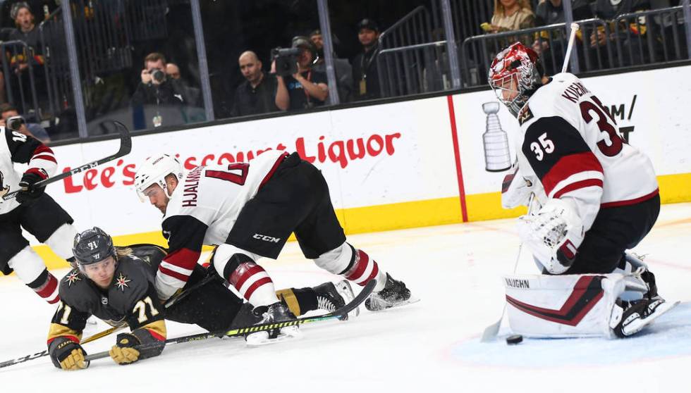 Golden Knights center William Karlsson (71) slips on the ice while trying to get the puck in ag ...