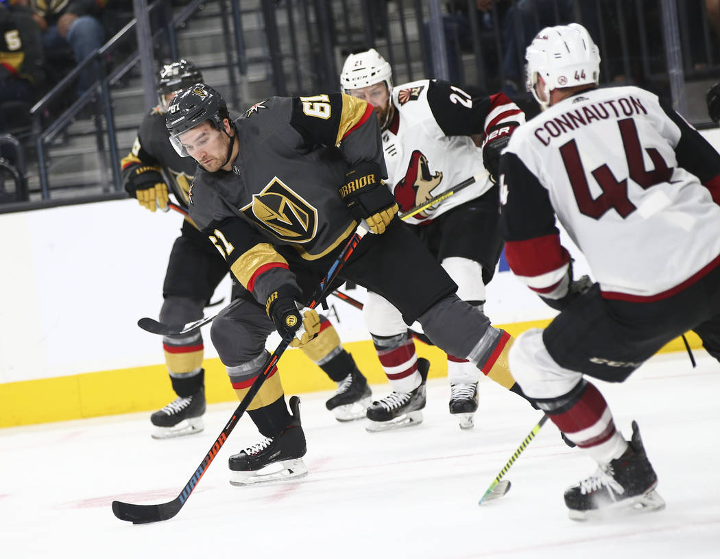 Golden Knights right wing Mark Stone (61) moves the puck around Arizona Coyotes defenseman Kevi ...