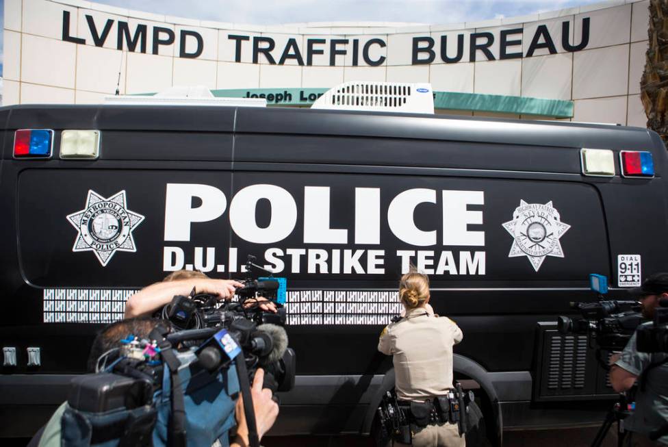 Metropolitan Police Department traffic officer A. Simon adds a marking to indicate 500 arrests ...