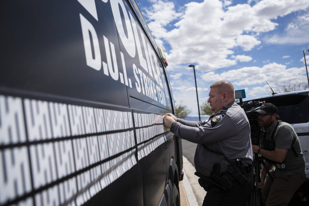 Nevada Highway Patrol trooper Dan Slattery adds a marking to indicate 500 arrests by the DUI St ...