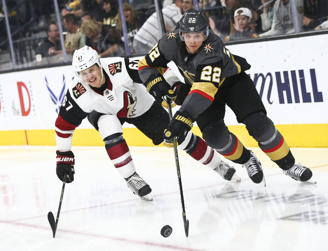 Golden Knights defenseman Nick Holden (22) moves the puck past Arizona Coyotes left wing Lawson ...