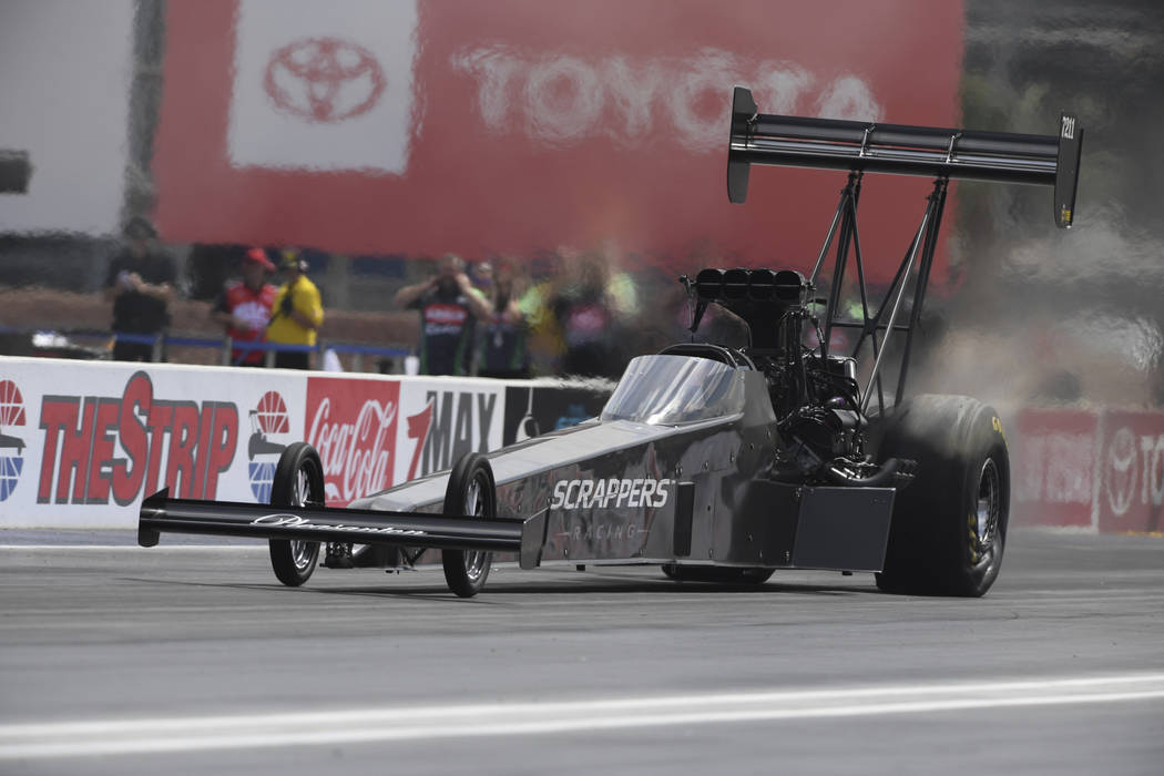 In this photo provided by the NHRA, Mike Salinas drives in the first day of Top Fuel qualifying ...