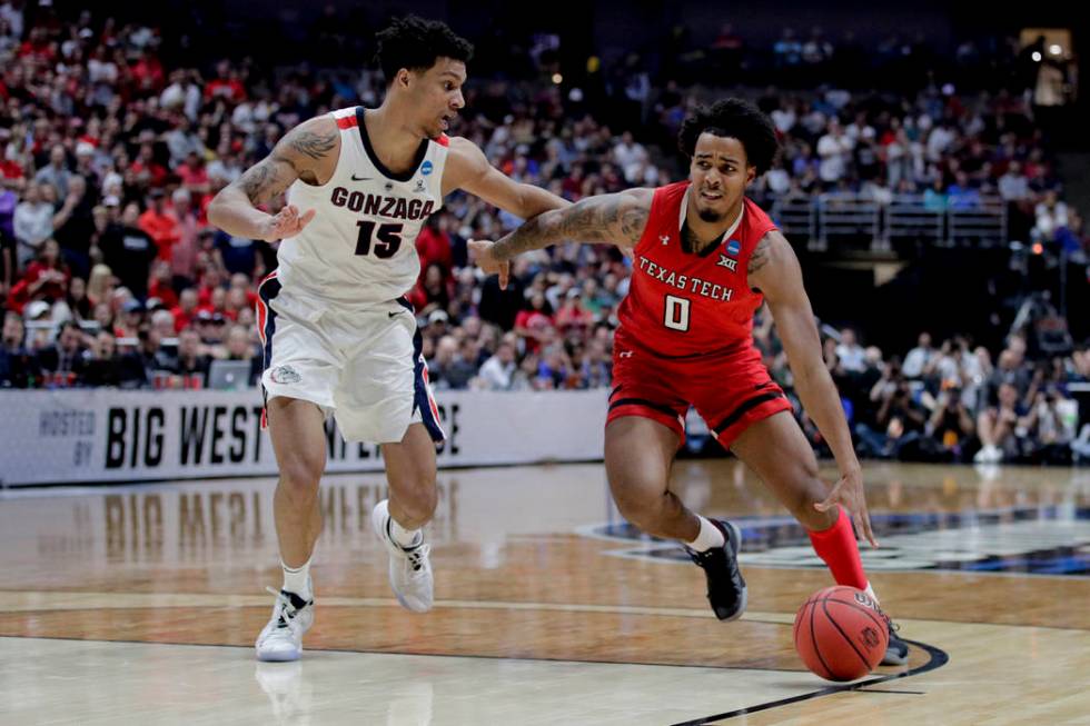 Texas Tech guard Kyler Edwards drives to the basket around Gonzaga forward Brandon Clarke durin ...