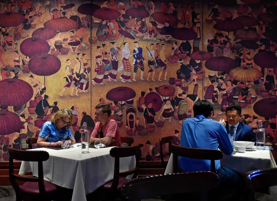 Many murals decorate the dining room at Lotus of Siam restaurant in Las Vegas. (David Becker/La ...