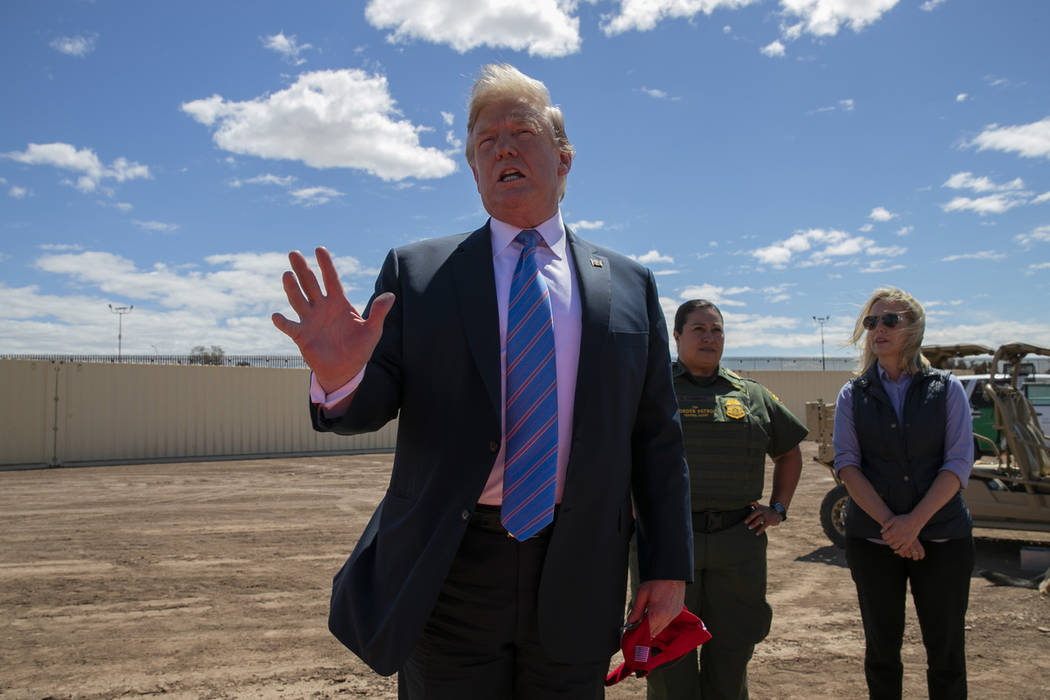 President Donald Trump speaks as he visits a new section of the border wall with Mexico in Cale ...