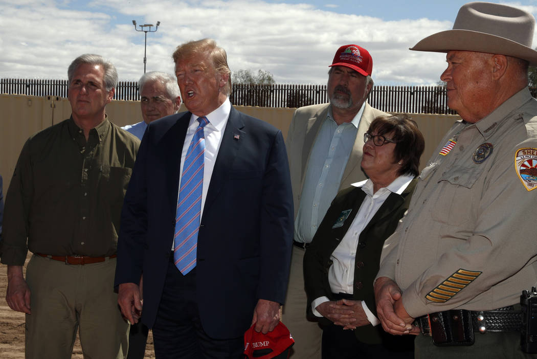 President Donald Trump speaks as he visits a new section of the border wall with Mexico in Cale ...