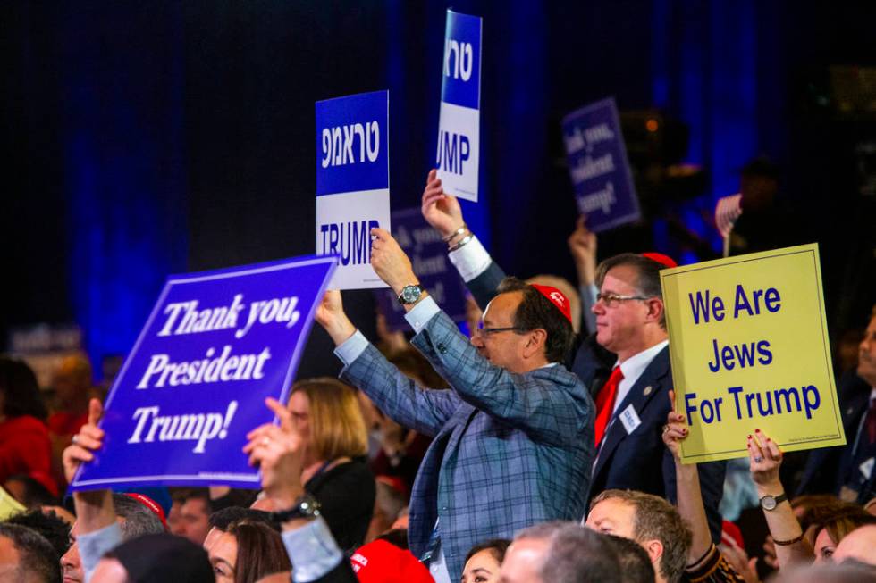 Attendees applaud President Donald J. Trump while he addresses the Republican Jewish Coalition ...