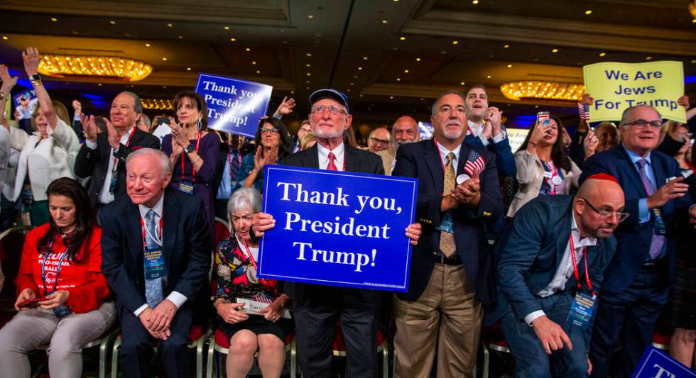 Attendees applaud President Donald J. Trump while he addresses the Republican Jewish Coalition ...