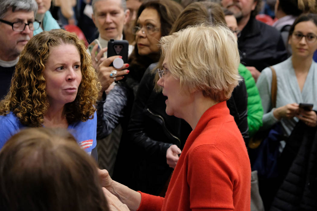 Democratic presidential candidate Sen. Elizabeth Warren, D-Mass., talks to crowd members after ...