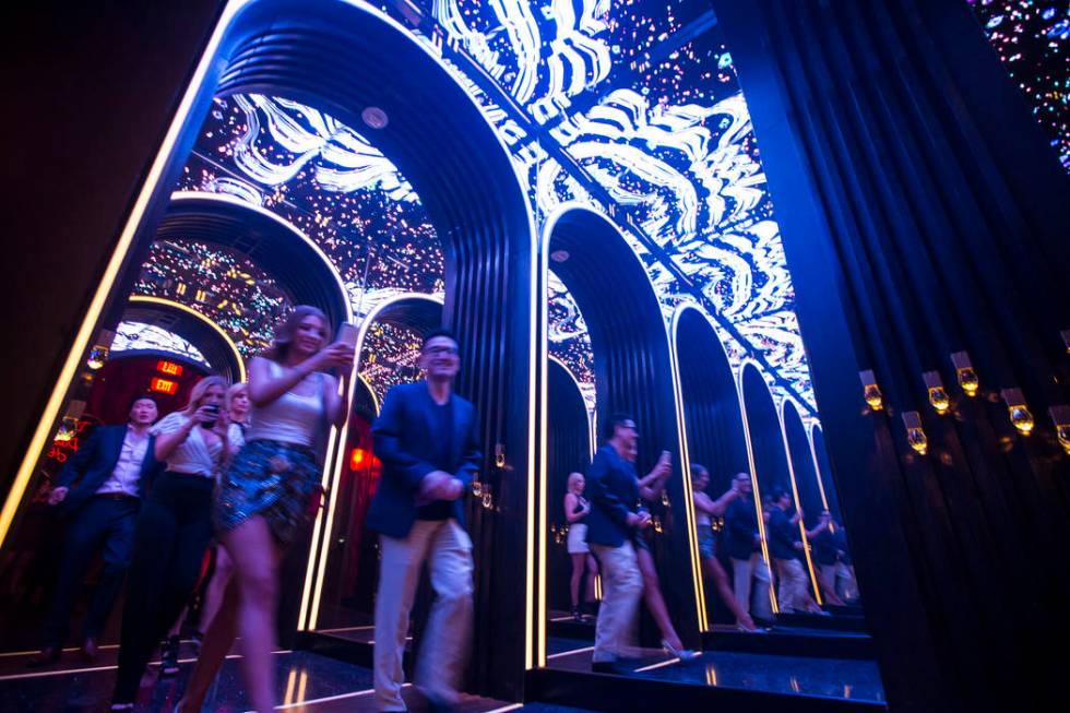 Attendees walk through a mirrored hallway to enter Kaos, the new dayclub and nightclub at the P ...