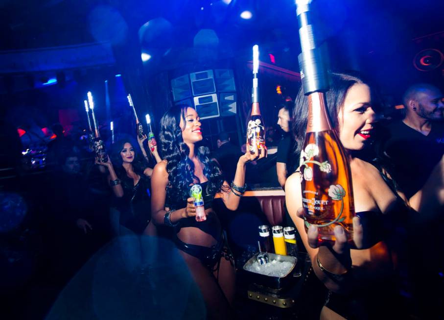 Bottles of champagne are delivered to a table in the nightclub area during the grand opening we ...