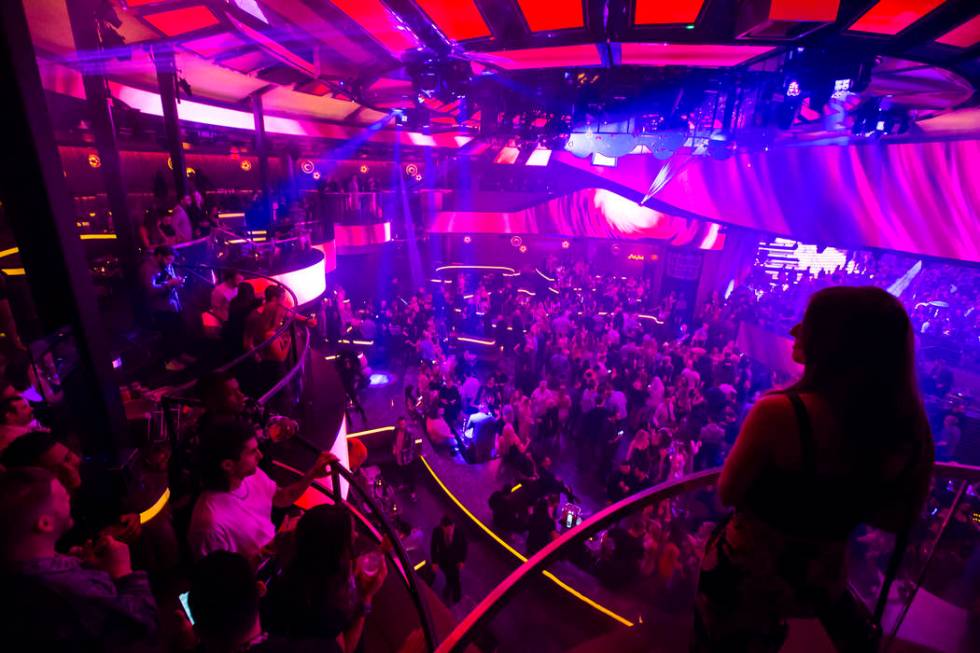 Attendees take in views of the nightclub from the mezzanine during the grand opening weekend of ...