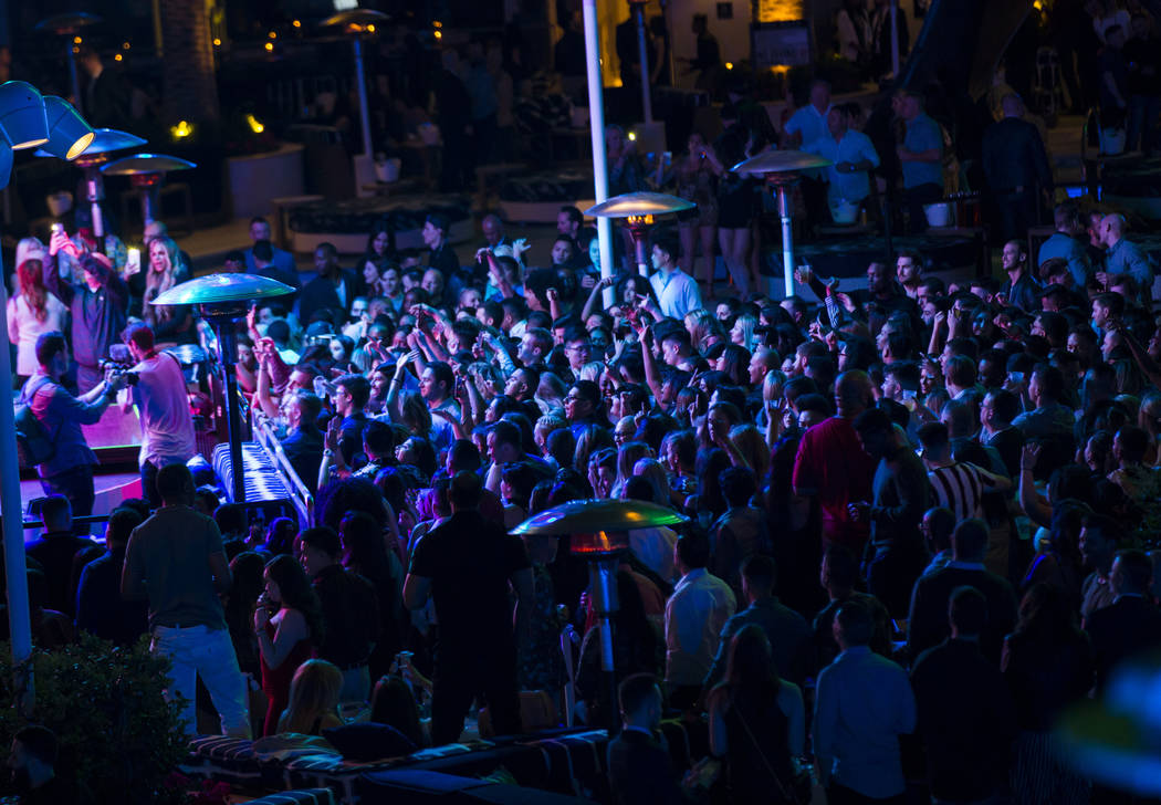 Attendees dance and listen to music during the grand opening weekend of Kaos, the new dayclub a ...