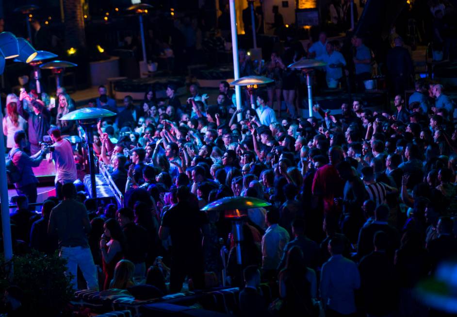 Attendees dance and listen to music during the grand opening weekend of Kaos, the new dayclub a ...