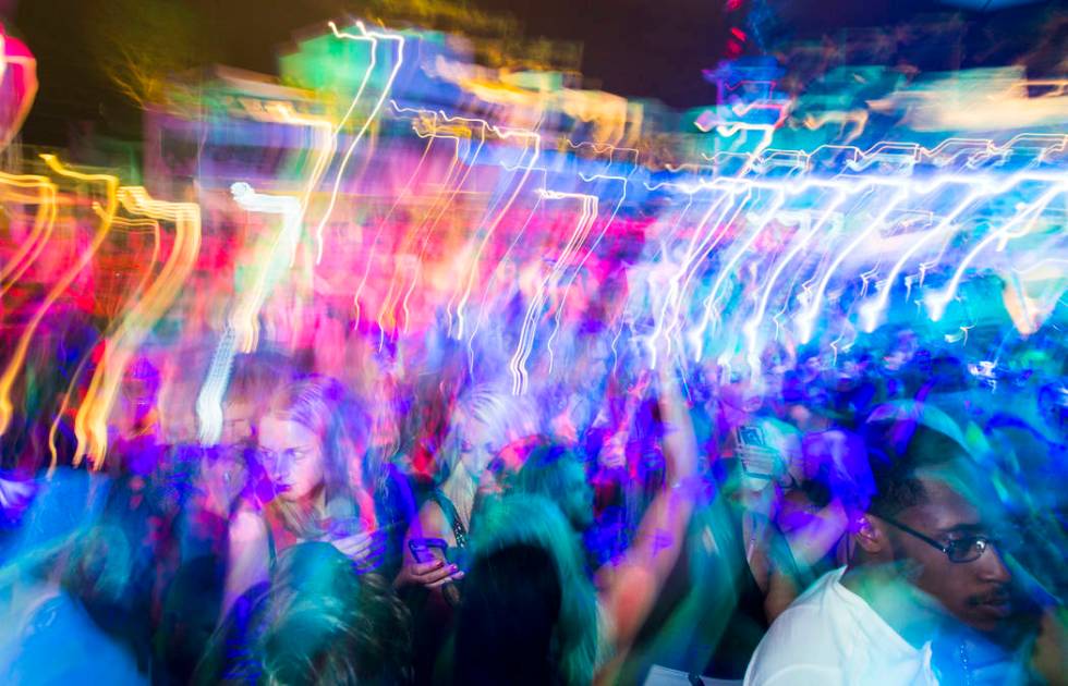 Attendees dance and listen to music as performers entertain by the outdoor stage during the gra ...