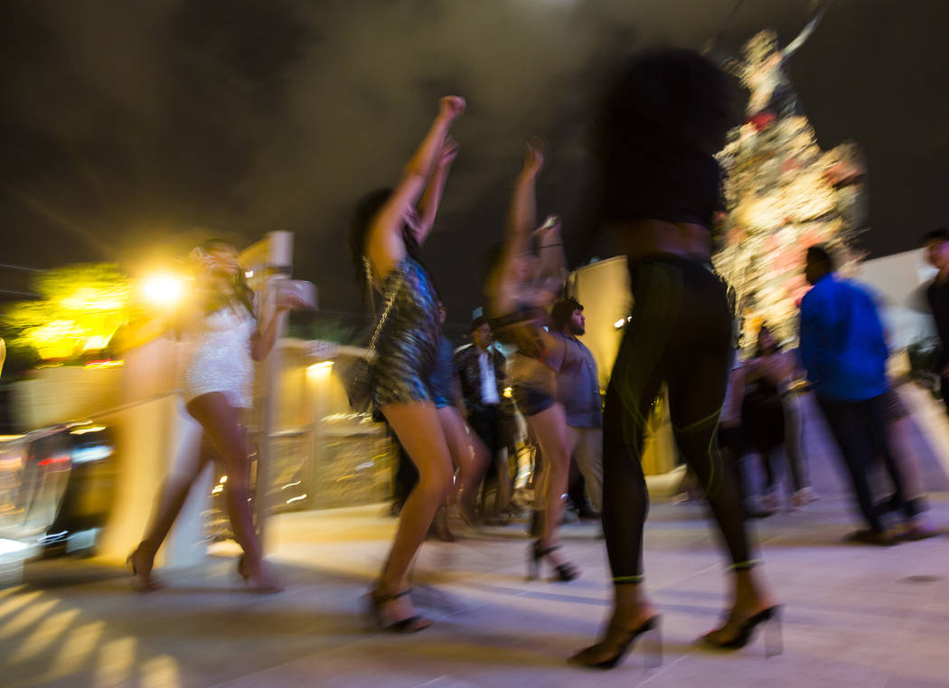 Attendees walk through the entrance for the grand opening weekend of Kaos, the new dayclub and ...